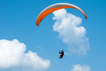 Paraglider flying in the sky on a paraglider. Paragliding.