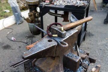 Anvil, bracelet and hammer.