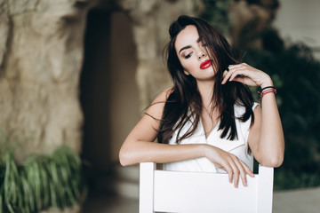 Fototapeta premium Beautiful, glamour, sexy model in white dress posing at hotel.