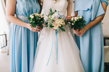 Wedding bride and your girlfriends in blue dress with bouquets