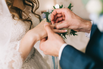 Groom puts wedding ring