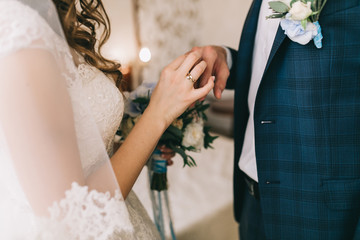 Groom puts wedding ring