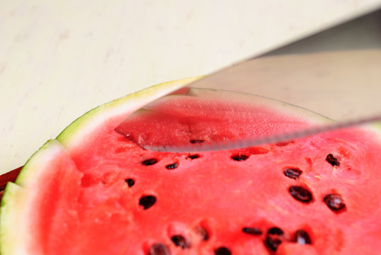 Cut pieces of ripe watermelon on a plate close-up.
