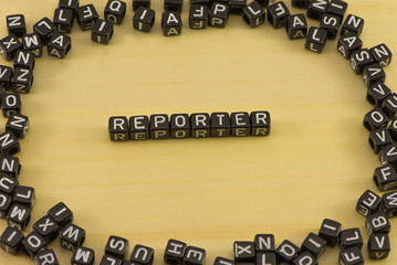 The word reporter on wood background