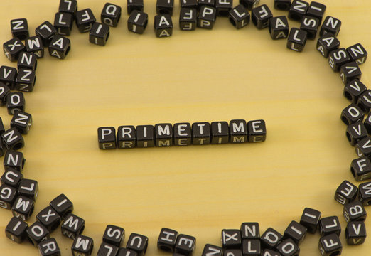 The word primetime on wood background