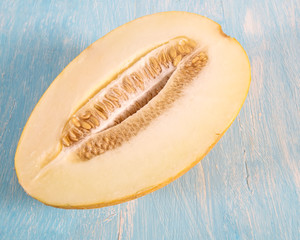 Cut fresh melon on a blue wooden background