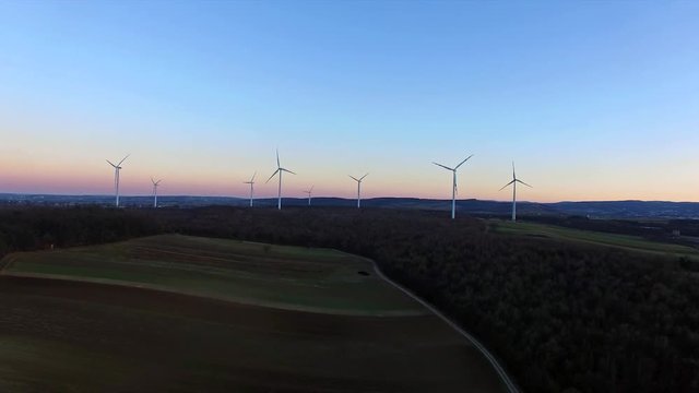 Wind turbines on field, filmed at susnet with a drone