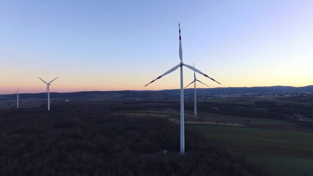 Wind turbines on field, filmed at susnet with a drone