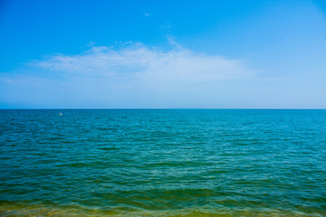Adriatic Sea coast view. Seashore of Italy, summer sandy beach with clouds on horizon.