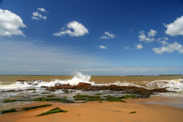 Strong wave hitting rocks on the beach