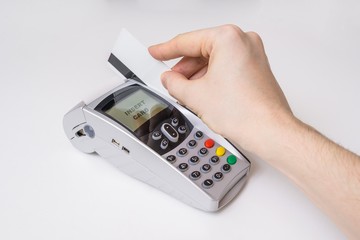 Customer is swiping magnetic credit card in payment terminal.