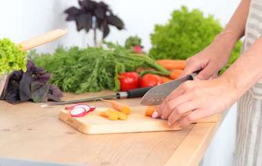 Fresh vegetables on the cutting board are falling in the pot, concept of cooking