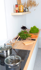 Fresh vegetables on the cutting board are falling in the pot, concept of cooking