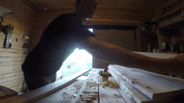 Man work with wood plank. Woodworking footage