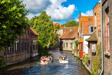 Naklejka premium Tourist boat on canal in Bruges