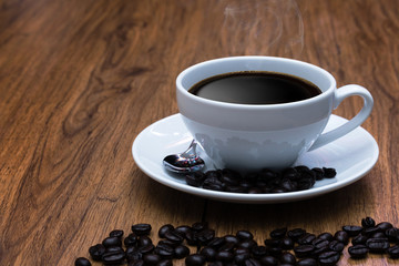 Coffee cup and coffee beans on table ,   break or breakfast .