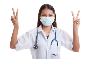 Fototapeta na wymiar Young Asian female doctor show victory sign with both hands.