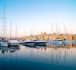Fototapeta premium Sailing boats on Senglea marina in Grand Bay, Valetta, Malta