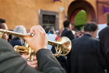Musician playing trumpet close up detail of hands and instrument