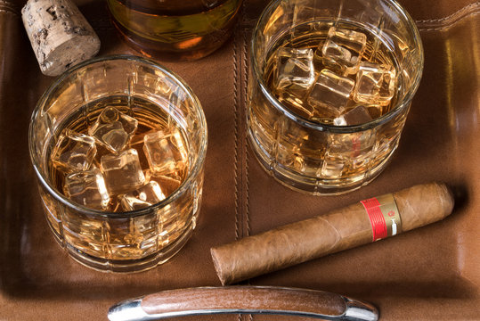 Adult Beverage with a Cigar on a Leather Tray