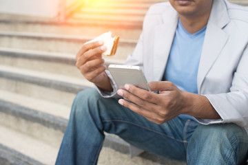 indian business male eating bread