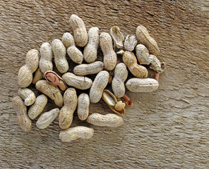 Roasted salted peanuts on rustic barn wood