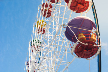 Ferris wheel closeup on the background of blue sky