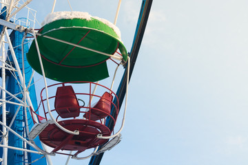 Ferris wheel closeup on the background of blue sky