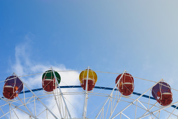 Ferris wheel on the background of blue sky