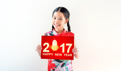 Happy chinese new year, young asian girl in Chinese traditional dress (Cheongsam) holding greeting card with smiling face standing on white background and copy space. Clipping path on greeting card.