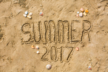 Sandy beach closeup, Seacoast sand background. Text Summer 2017.