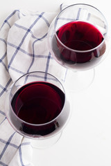 Red wine in glasses on a white background