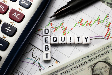 Debt and equity letter cube on white candle stick chart background. conceptual image for D/E ratio in stock investment.