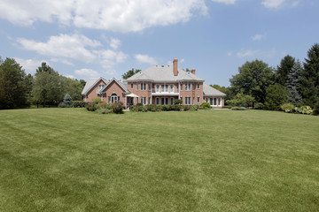 Rear view of luxury brick home