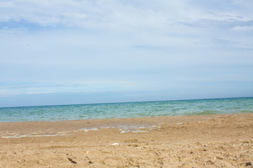 Fototapeta na wymiar Adriatic Sea coast view. Seashore of Italy, summer sandy beach with clouds on horizon.