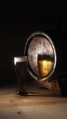 Beer mugs and barrel on a wooden background