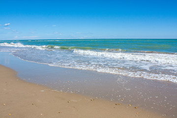 Fototapeta na wymiar Adriatic Sea coast view. Seashore of Italy, summer sandy beach with clouds on horizon.