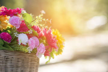 A bouquet of colorful flowers in a bamboo basket.