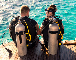 Couple divers preparing to dive, close up