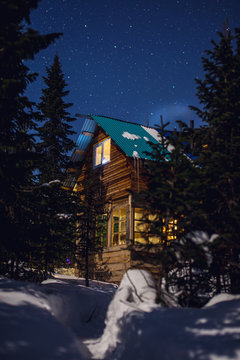 fabulous winter image of a wooden house with light