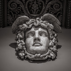 Fototapeta na wymiar Head with wreath detail of the ancient sculpture
