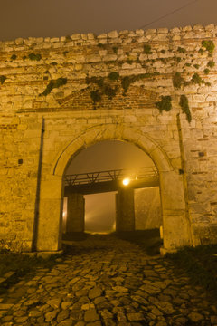 Old cobblestone path to Kalemegdan fortress at night covered in fog, Belgrade, Serbia
