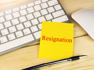 Resignation on sticky note on work table