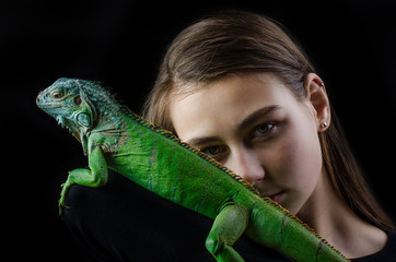 Perfect portrait beautiful girl and green iguana in the studio