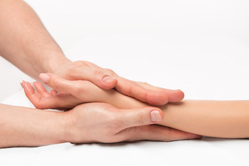 Obraz na płótnie Canvas stroking massage of hands close up on a white background