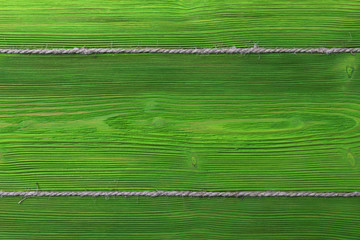 green wooden texture background with old rope