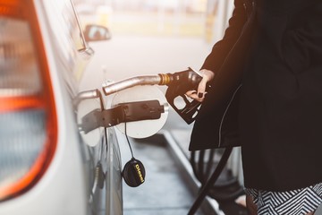 Woman refueling car with diesel