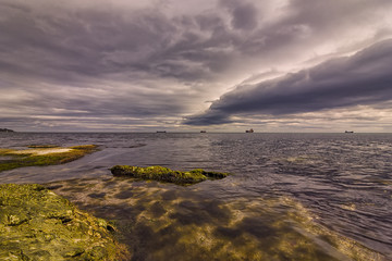 Exciting long exposure day seascape with stormy clouds