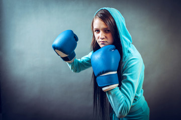 Boxer woman during boxing exercise making direct hit