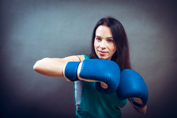 Boxer woman during boxing exercise making direct hit